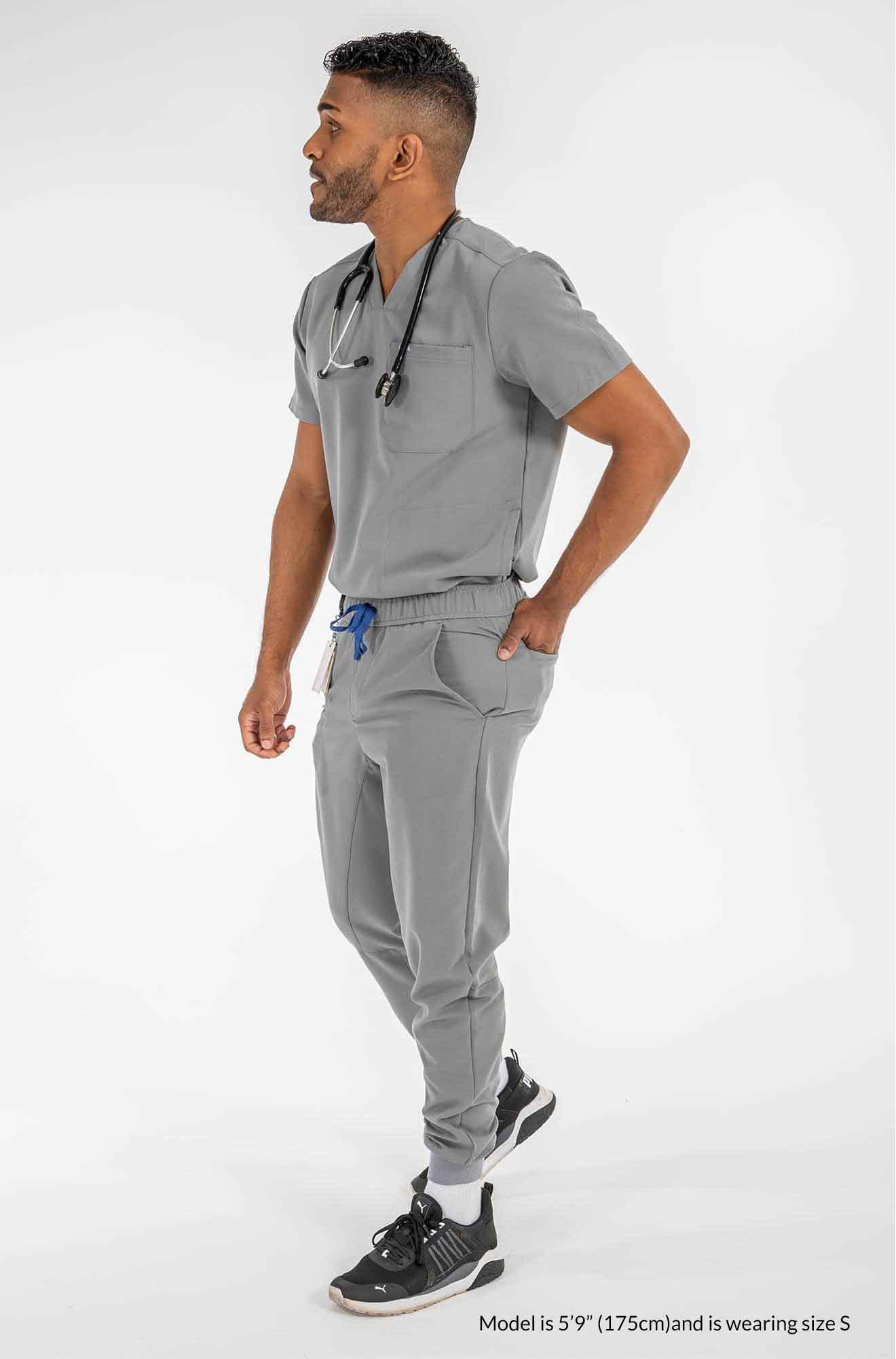 Men's AESON Scrub Top, Gentleman featuring the scrub pants, His hand is on the back of the scrub pants #colour_grey