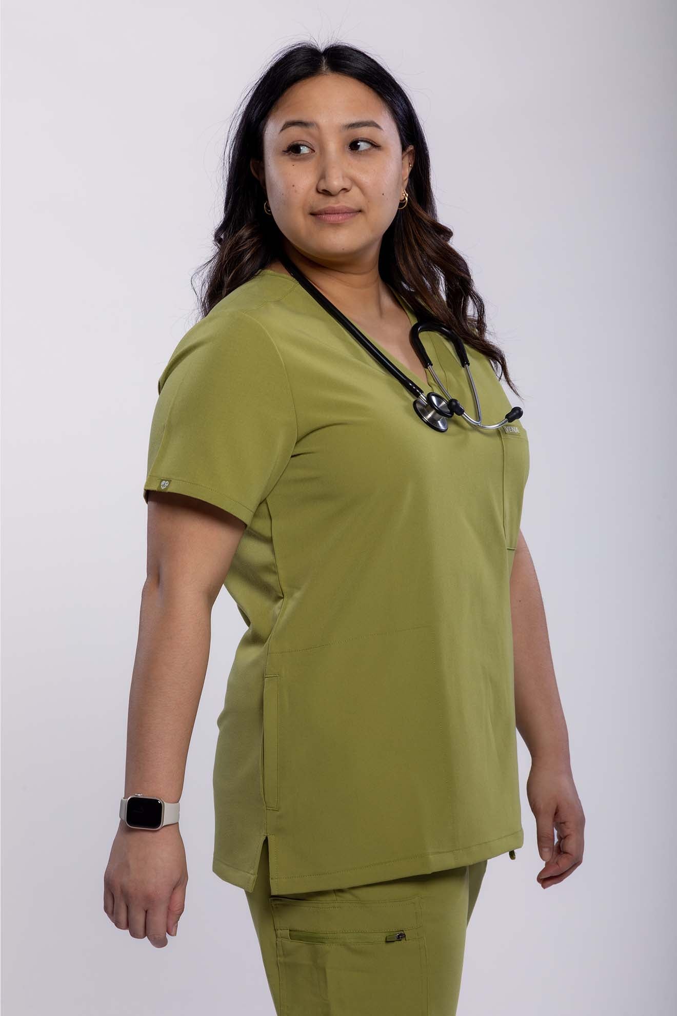 vena scrub top featuring side angle from the thigh up olive colour #colour_olive