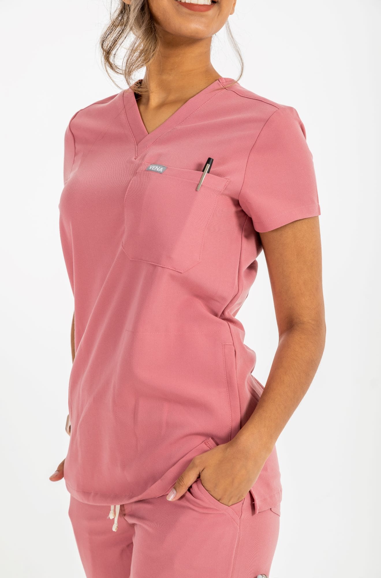 This pink scrub top features three functional pockets and extremely soft material. #colour_rose
