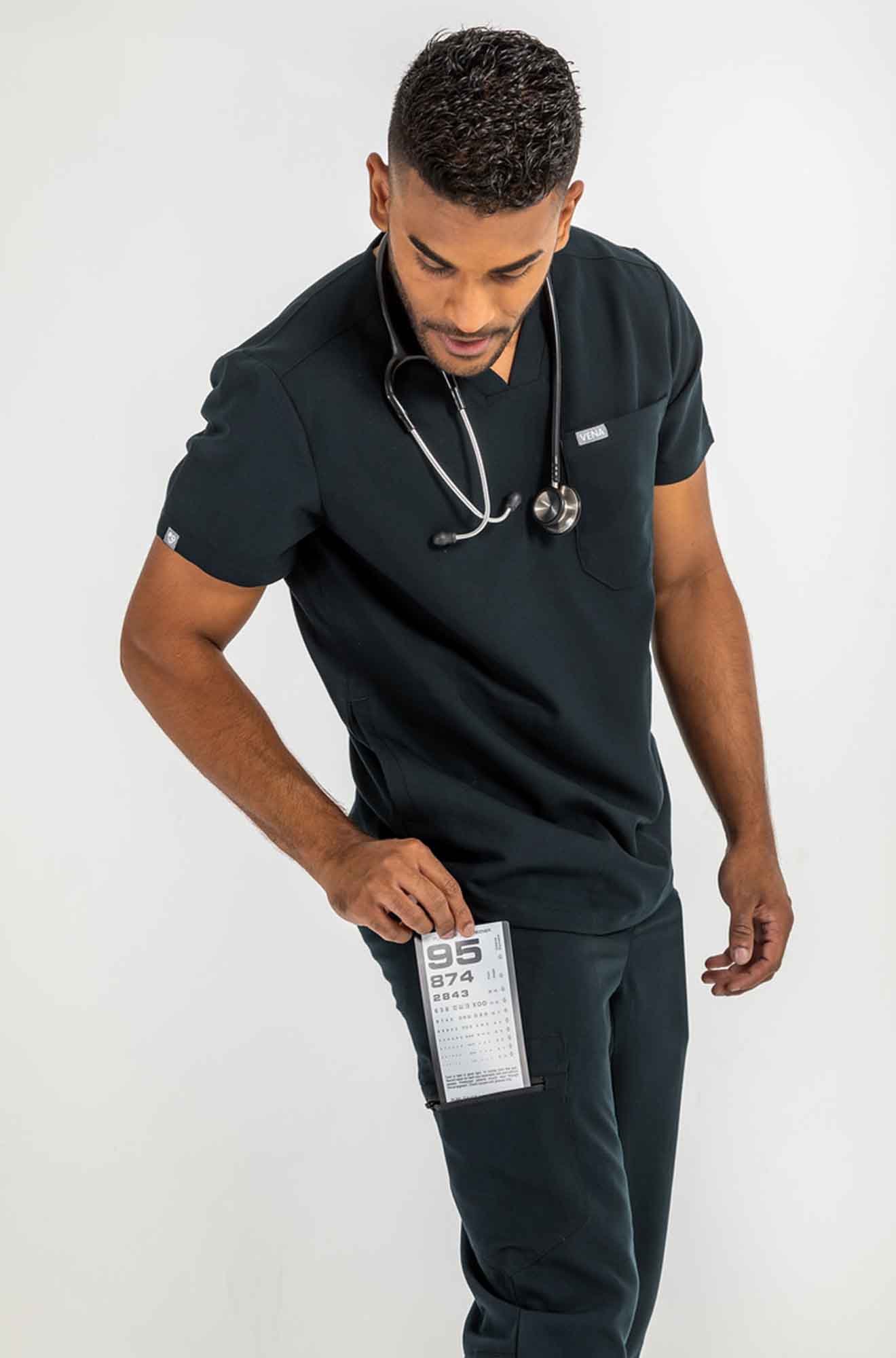 Men's DEX Jogger Scrub Pant, gentleman putting small card in his side pockt pant #colour_black