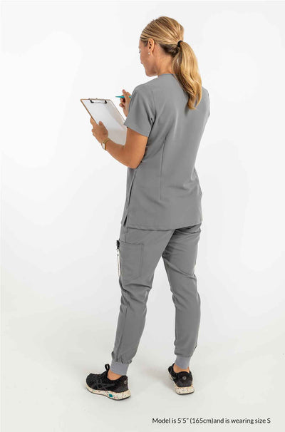 Women's SAYA Jogger Scrub Pant, Lady featuring the back of scrub set holding a checklist #colour_grey