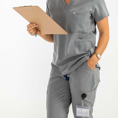 Women's SAYA Jogger Scrub Pant, lady wearing scrub set, shes holding checklist on her right hand #colour_grey