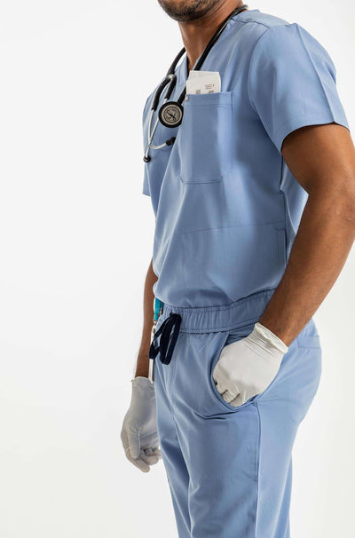 Men's DEX Jogger Scrub Pant, Ceil Blue Pants, His hands in the side pocket of the scrub pant#colour_ceil-blue