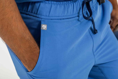Men's DEX Jogger Scrub Pant, Person hand inside the right pocket of scrub pant#colour_royal-blue