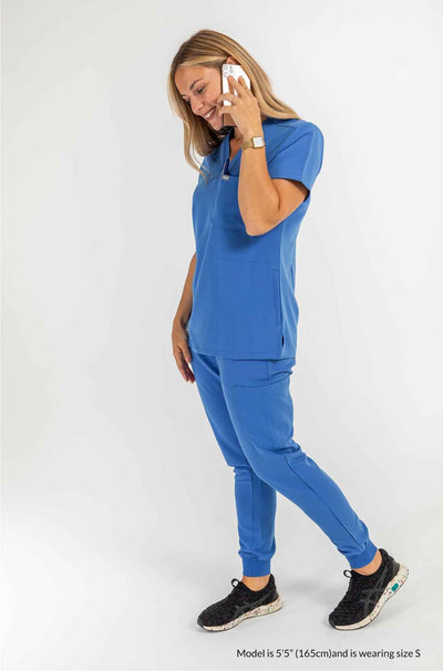 Women's ATRIUM Scrub Top, Lady using mobile and speaking to someone #colour_royal-blue